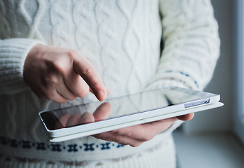 Image showing The man uses a tablet PC. Modern gadget in hand.