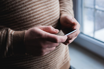 Image showing The man is using a smartphone. Modern mobile phone in hand.