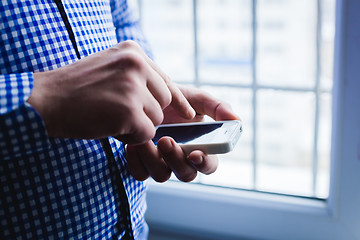 Image showing The man is using a smartphone. Modern mobile phone in hand.