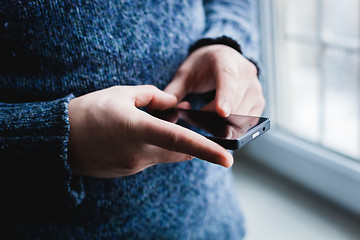 Image showing The man is using a smartphone. Modern mobile phone in hand.