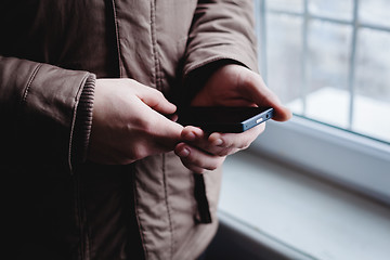 Image showing The man is using a smartphone. Modern mobile phone in hand.