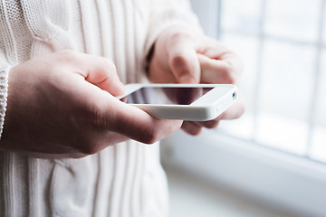 Image showing The man is using a smartphone. Modern mobile phone in hand.