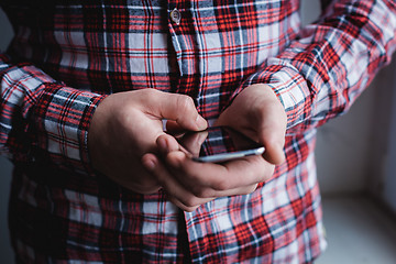 Image showing The man is using a smartphone. Modern mobile phone in hand.