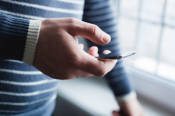 Image showing The man is using a smartphone. Modern mobile phone in hand.