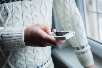 Image showing The man is using a smartphone. Modern mobile phone in hand.