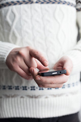 Image showing The man is using a smartphone. Modern mobile phone in hand.