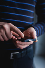 Image showing The man is using a smartphone. Modern mobile phone in hand.