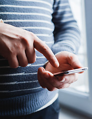 Image showing The man is using a smartphone. Modern mobile phone in hand.