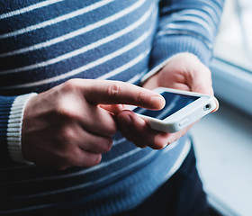 Image showing The man is using a smartphone. Modern mobile phone in hand.