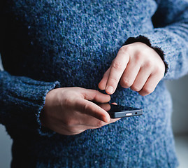 Image showing The man is using a smartphone. Modern mobile phone in hand.