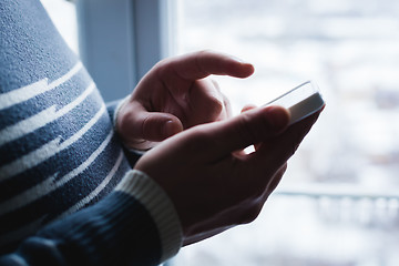 Image showing The man is using a smartphone. Modern mobile phone in hand.