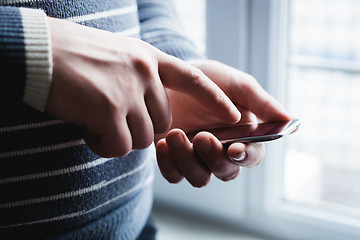 Image showing The man is using a smartphone. Modern mobile phone in hand.