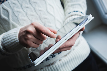 Image showing The man uses a tablet PC. Modern gadget in hand.