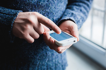 Image showing The man is using a smartphone. Modern mobile phone in hand.