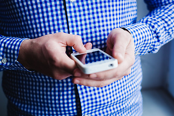 Image showing The man is using a smartphone. Modern mobile phone in hand.