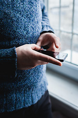 Image showing The man is using a smartphone. Modern mobile phone in hand.