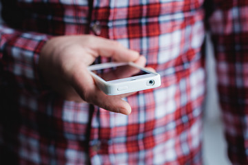 Image showing The man is using a smartphone. Modern mobile phone in hand.