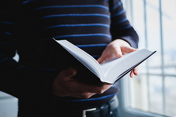 Image showing Man reading. Book in his hands.