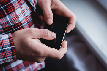 Image showing The man is using a smartphone. Modern mobile phone in hand.