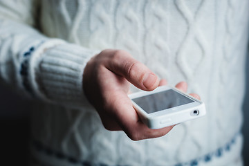 Image showing The man is using a smartphone. Modern mobile phone in hand.