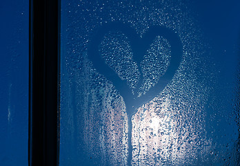 Image showing Moonlight through the window. Sweaty glass and heart