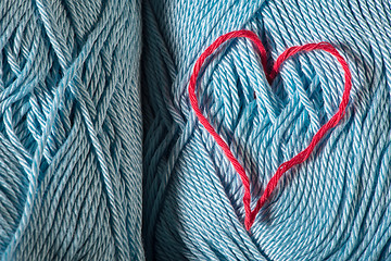 Image showing Knitted red heart on blue