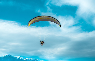 Image showing Paragliding fly on blue sky