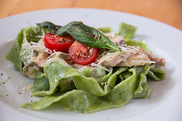 Image showing Italian pasta with  spinach and tomatoes