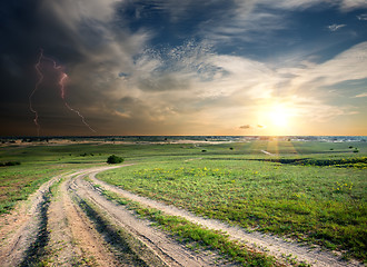 Image showing Storm over the road in field