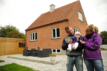 Image showing Happy family in front of house