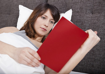 Image showing Young girl reading a book