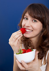 Image showing Eating strawberries