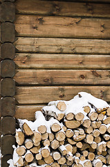 Image showing Birch fire wood at a wall of the house in winter