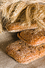 Image showing Rye bread and wheat on cloth sack, close-up