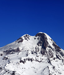 Image showing Top of Mount Kazbek at sun winter day