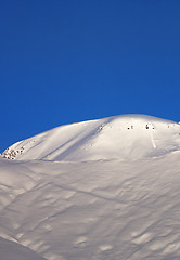 Image showing Off-piste slope and blue cloudless sky in nice winter morning