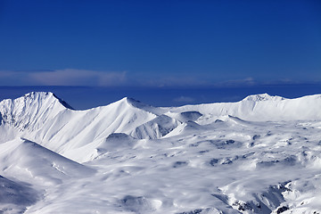 Image showing Snowy plateau at sunny day and blue sky