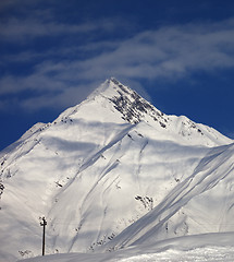 Image showing Ski slope and blue sky with clouds at sunny day