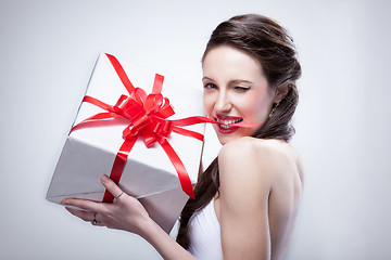 Image showing Young smiling woman holding gift