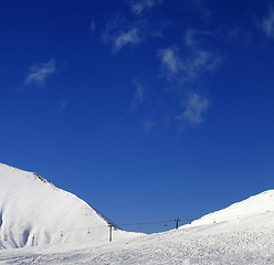 Image showing Ski slope with chair lift at sunny winter day
