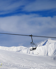 Image showing Chair lift and off-piste slope at nice sun day