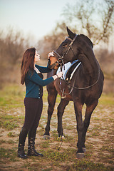 Image showing Young woman with a horse on nature