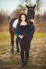 Image showing Young woman with a horse on nature