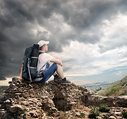 Image showing Tourist sitting on the rocks