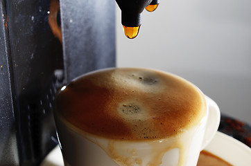 Image showing cup of espresso and coffee machine
