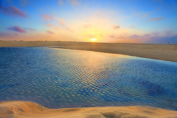 Image showing Sunrise over golden sands and azure waters