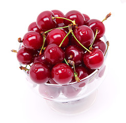 Image showing Ripe fresh cherry in the glass isolated on white background