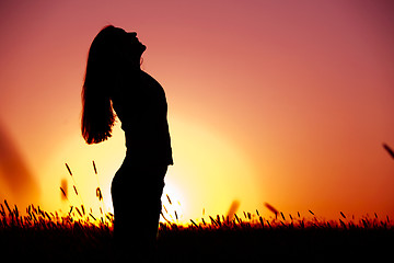 Image showing Woman relaxing at sunset