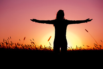 Image showing Woman relaxing at sunset