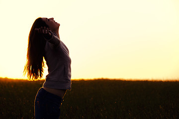 Image showing Woman relaxing at sunset